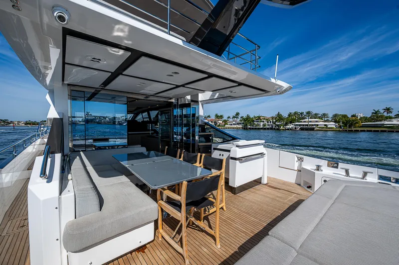  Yacht Photos Pics Luxurious 2019 Azimut S7 yacht deck with seating, table, and scenic waterfront view.