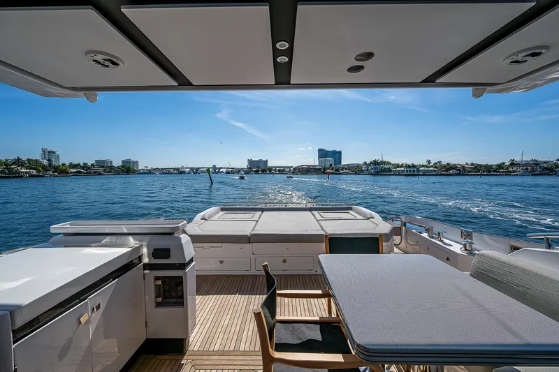  Yacht Photos Pics 2019 Azimut S7 yacht deck with dining area overlooking serene waterfront view.