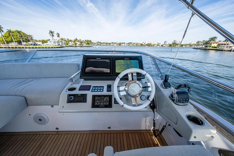  Yacht Photos Pics Cockpit view of 2019 Azimut S7 yacht with modern navigation system and scenic waterfront.
