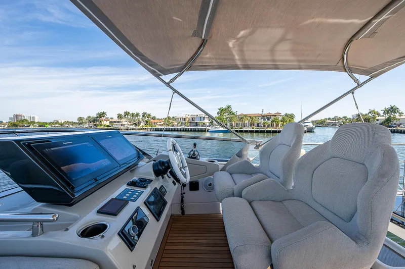  Yacht Photos Pics Cockpit view of 2019 Azimut S7 yacht with plush seating and scenic waterfront backdrop.