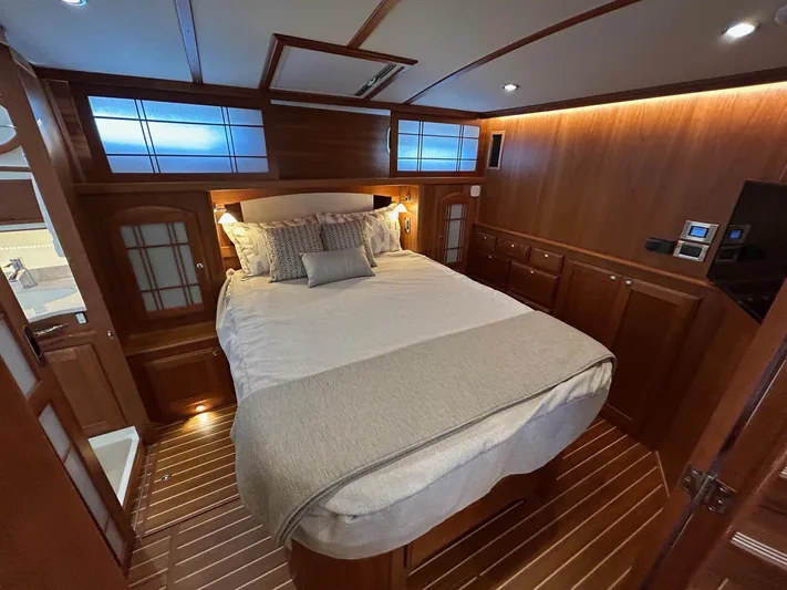 Fil The Tide Yacht Photos Pics Luxurious bedroom interior of 2021 Sabre 48 Salon Express yacht with elegant wood finish.