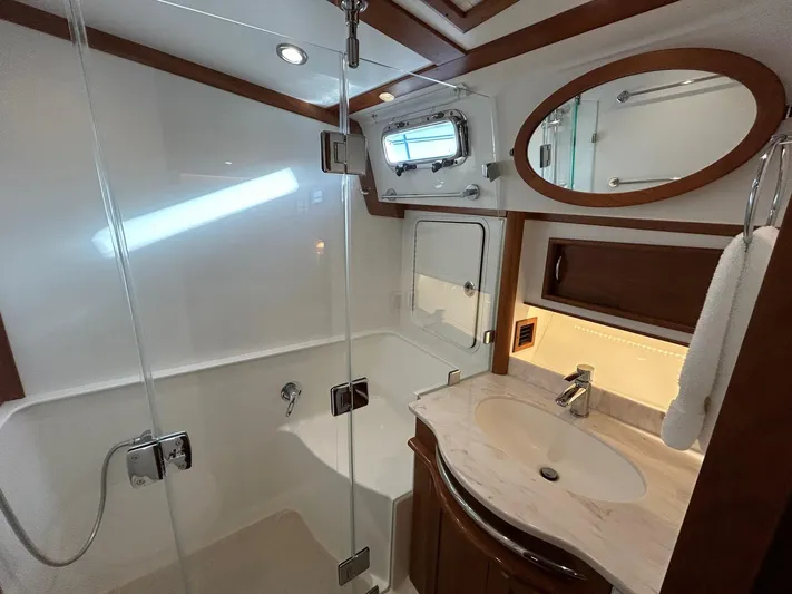 Fil The Tide Yacht Photos Pics Luxurious bathroom in 2021 Sabre 48 Salon Express yacht with modern fixtures and elegant design.