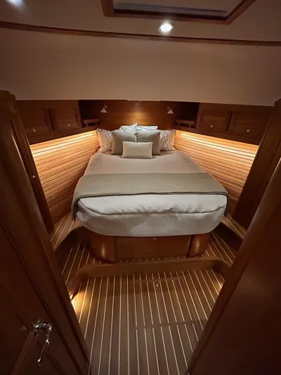Fil The Tide Yacht Photos Pics Luxurious cabin interior of 2021 Sabre 48 Salon Express yacht, featuring elegant wood finishes.