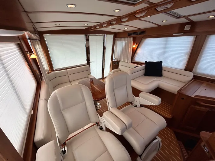 Fil The Tide Yacht Photos Pics 2021 Sabre 48 Salon Express interior with white seating and wooden accents.