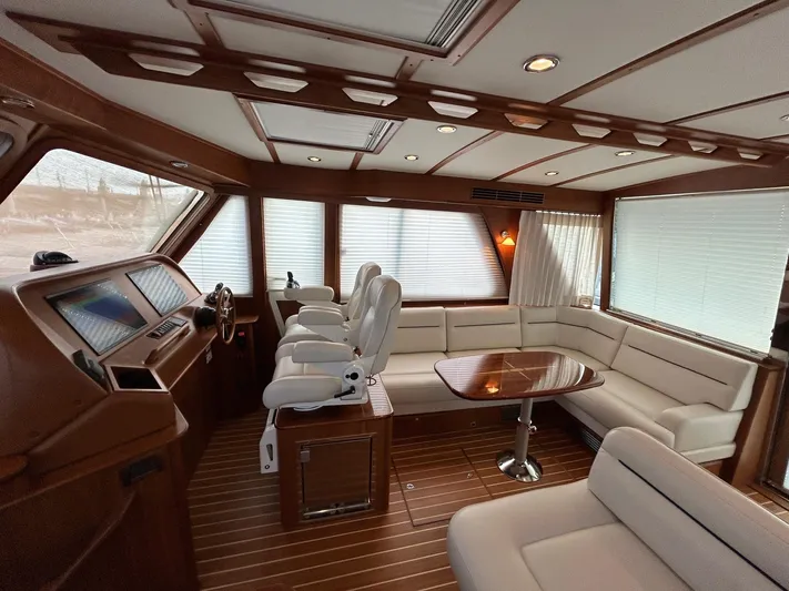 Fil The Tide Yacht Photos Pics Luxurious interior of 2021 Sabre 48 Salon Express yacht with elegant seating and wood finishes.