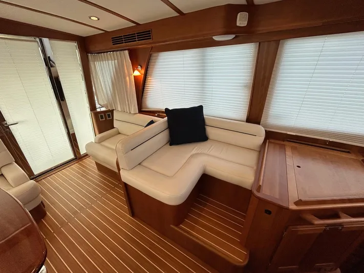 Fil The Tide Yacht Photos Pics Interior of 2021 Sabre 48 Salon Express with elegant wood finish and plush seating.