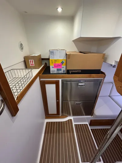 Fil The Tide Yacht Photos Pics 2021 Sabre 48 Salon Express interior with storage boxes and wooden flooring.