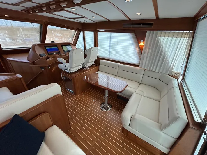 Fil The Tide Yacht Photos Pics Luxurious interior of 2021 Sabre 48 Salon Express yacht with elegant seating and helm.
