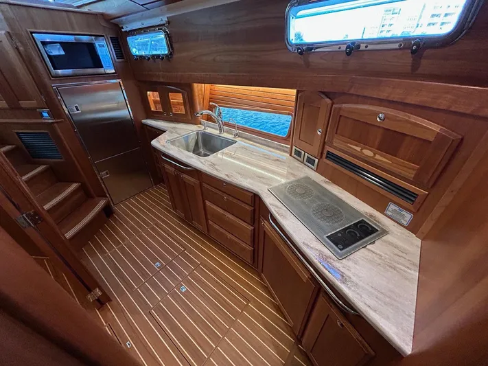 Fil The Tide Yacht Photos Pics Luxurious kitchen interior of 2021 Sabre 48 Salon Express yacht with wood finish.