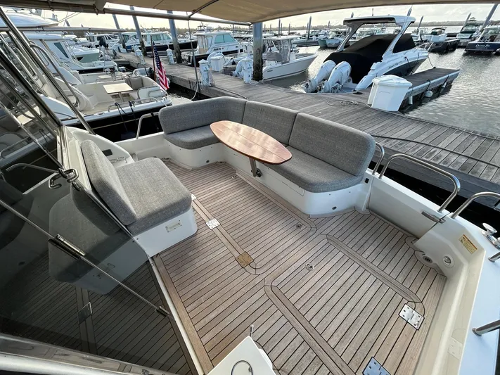 Fil The Tide Yacht Photos Pics 2021 Sabre 48 Salon Express yacht with spacious seating and wooden deck at marina.