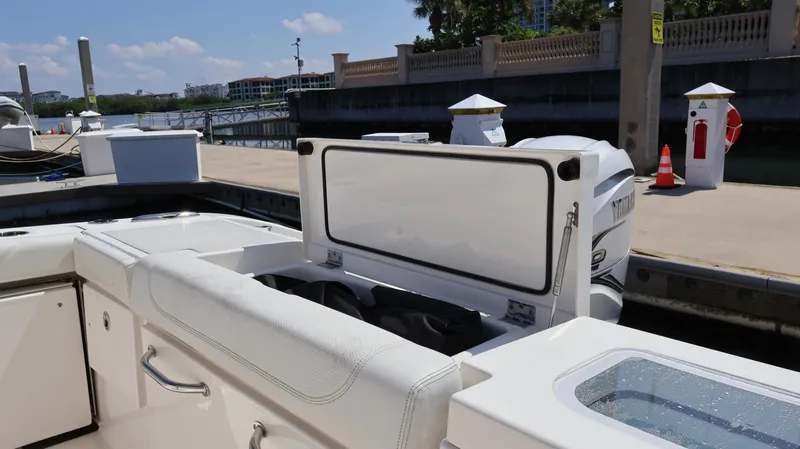  Yacht Photos Pics 2023 Pursuit OS 355 Offshore boat at dock, featuring open storage compartment.