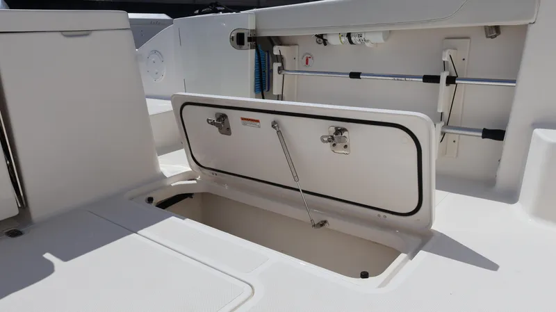  Yacht Photos Pics 2023 Pursuit OS 355 Offshore boat storage compartment with open hatch and hydraulic support.