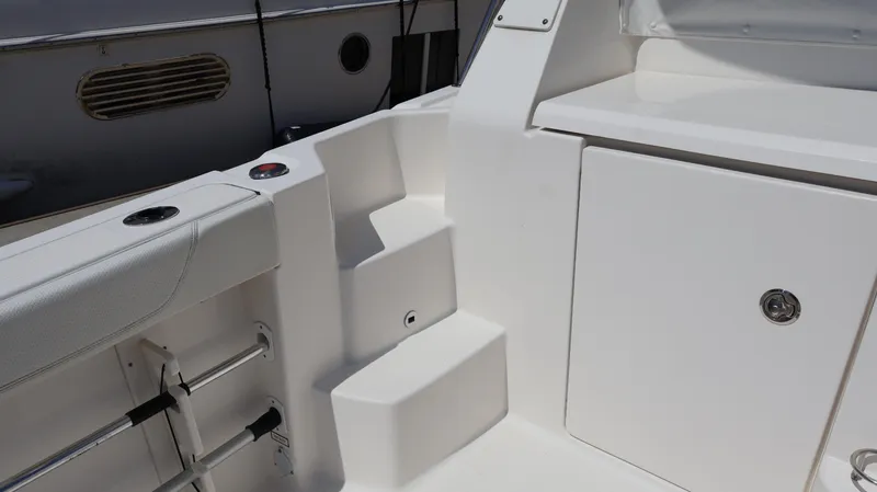  Yacht Photos Pics 2023 Pursuit OS 355 Offshore boat interior with seating and storage compartment.