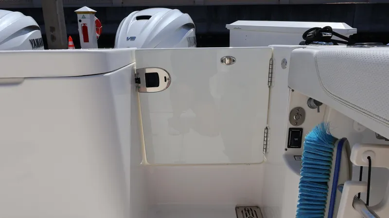  Yacht Photos Pics 2023 Pursuit OS 355 Offshore boat deck with Yamaha engines and cleaning brush.