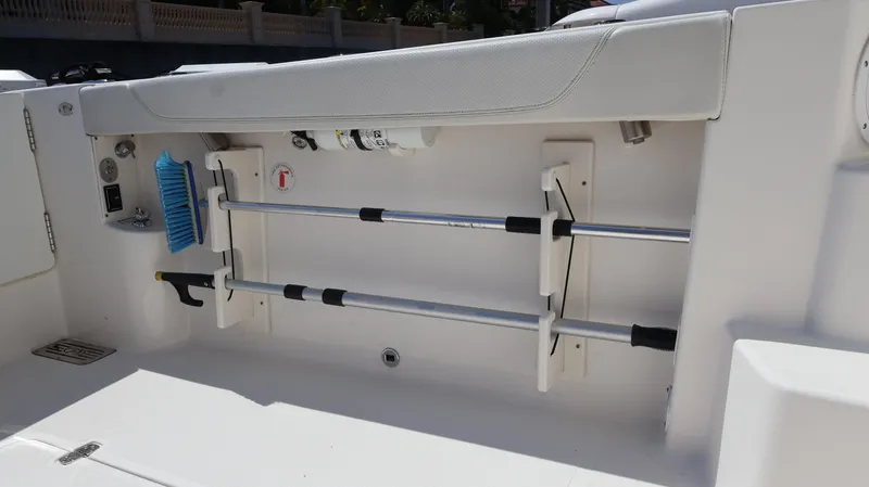  Yacht Photos Pics 2023 Pursuit OS 355 Offshore boat interior storage compartment with cleaning tools.