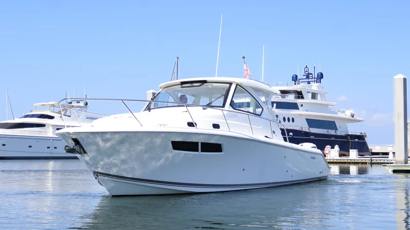  Yacht Photos Pics 2023 Pursuit OS 355 Offshore boat docked in marina, clear blue sky background.