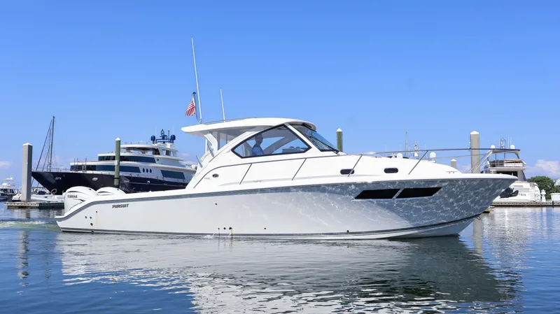  Yacht Photos Pics 2023 Pursuit OS 355 Offshore boat docked in a marina under clear blue skies.