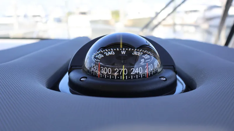  Yacht Photos Pics Compass on 2023 Pursuit OS 355 Offshore boat dashboard, close-up view.