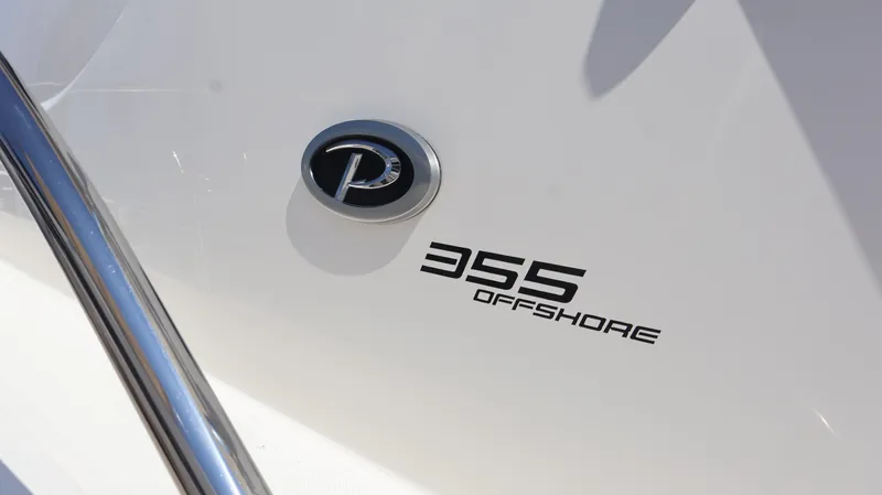  Yacht Photos Pics 2023 Pursuit OS 355 Offshore boat emblem and model name on hull.