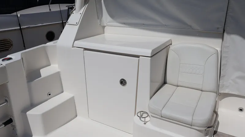  Yacht Photos Pics 2023 Pursuit OS 355 Offshore boat interior with white seating and storage compartment.