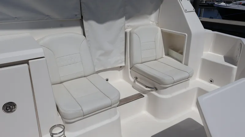  Yacht Photos Pics 2023 Pursuit OS 355 Offshore boat interior with two white cushioned seats.