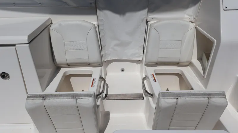  Yacht Photos Pics 2023 Pursuit OS 355 Offshore boat seating area with storage compartments.