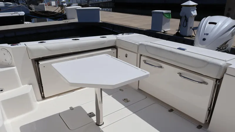  Yacht Photos Pics 2023 Pursuit OS 355 Offshore boat interior with seating and table setup.