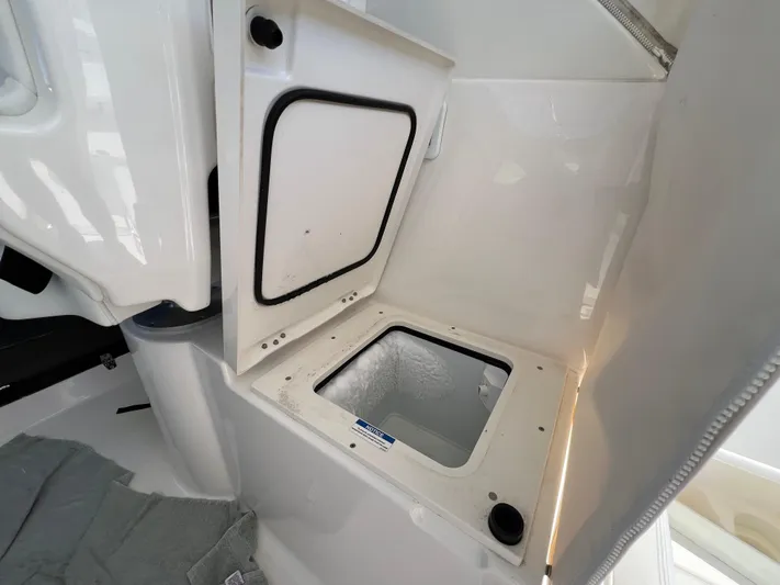  Yacht Photos Pics 2023 Pursuit OS 355 Offshore boat storage compartment with open hatch.