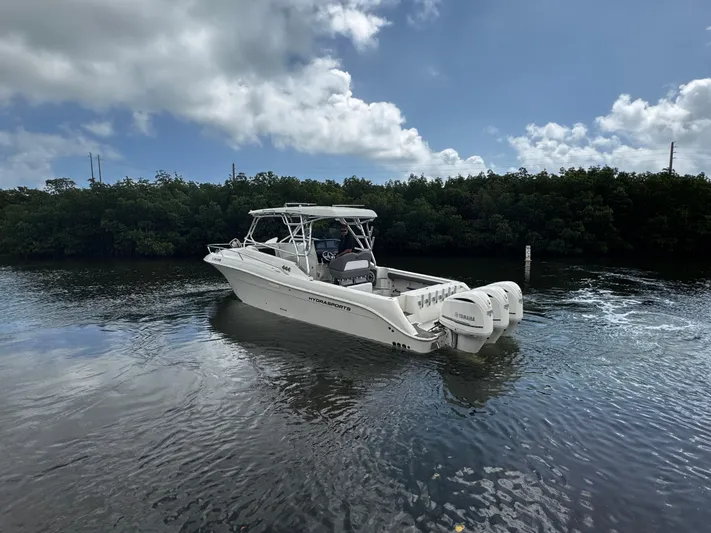  Yacht Photos Pics 2005 Hydra-Sports 3300 VX boat cruising on calm water under a partly cloudy sky.