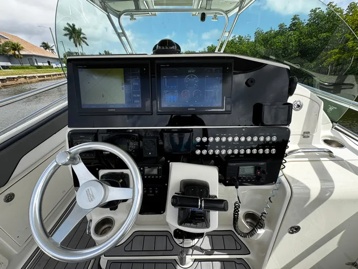  Yacht Photos Pics 2005 Hydra-Sports 3300 VX boat dashboard with steering wheel and navigation screens.