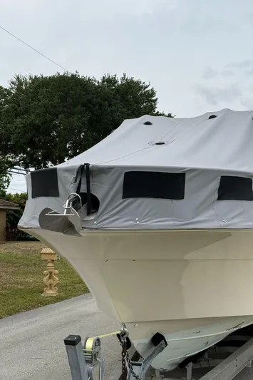  Yacht Photos Pics 2005 Hydra-Sports 3300 VX boat with cover on trailer, parked outdoors.