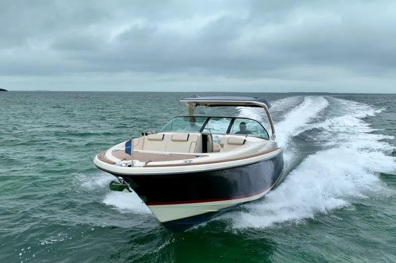 Twin Tides Yacht Photos Pics 2024 Chris-Craft Launch 35 GT cruising on open water under cloudy skies.