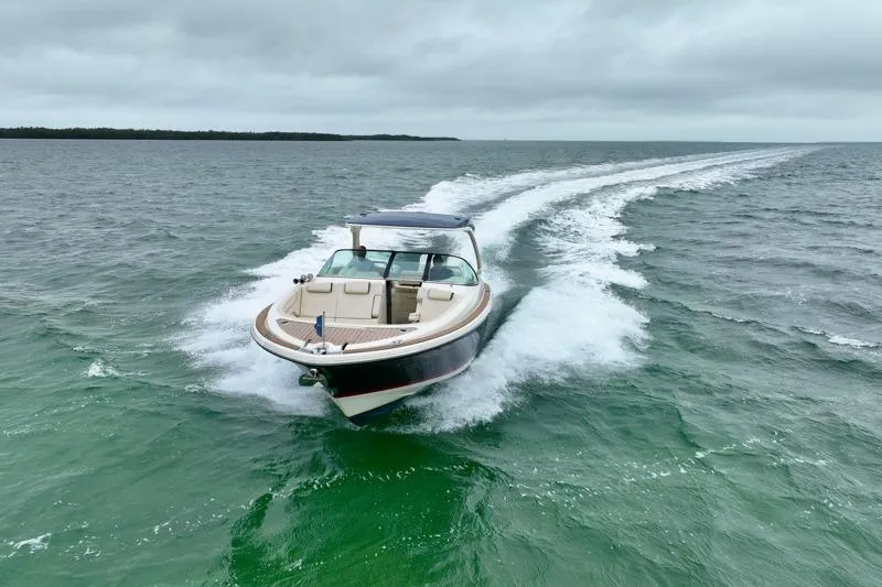 Twin Tides Yacht Photos Pics 2024 Chris-Craft Launch 35 GT cruising on open water under cloudy skies.