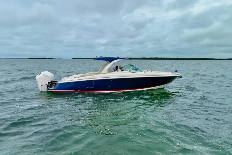 Twin Tides Yacht Photos Pics 2024 Chris-Craft Launch 35 GT boat cruising on open water under cloudy skies.