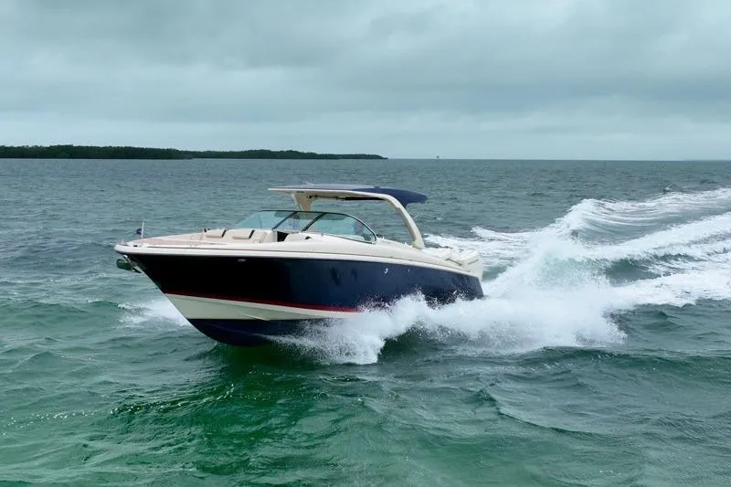 Twin Tides Yacht Photos Pics 2024 Chris-Craft Launch 35 GT cruising on open water under cloudy skies.