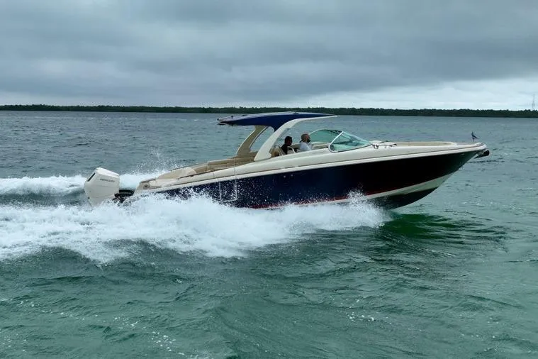 Twin Tides Yacht Photos Pics 2024 Chris-Craft Launch 35 GT cruising on open water under cloudy skies.