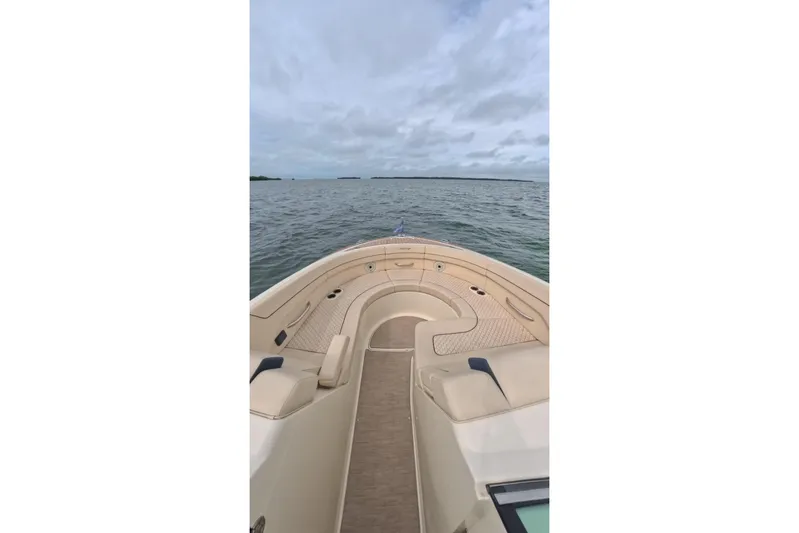 Twin Tides Yacht Photos Pics 2024 Chris-Craft Launch 35 GT boat cruising on open water under cloudy skies.