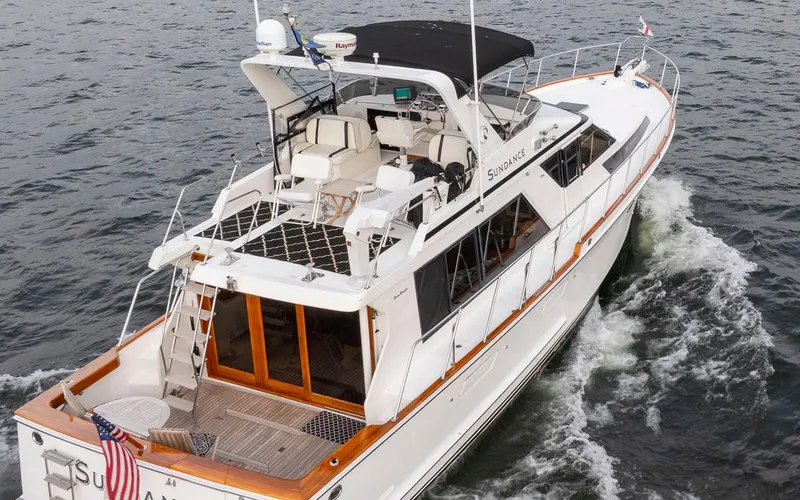  Yacht Photos Pics 1989 Ocean Alexander 50 Sedan yacht cruising on open water, rear view.