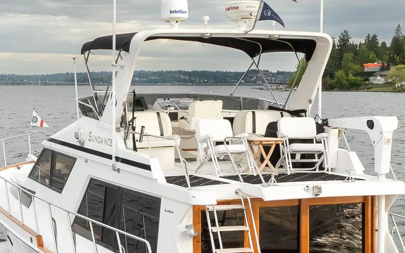  Yacht Photos Pics 1989 Ocean Alexander 50 Sedan yacht on a serene lake with lush green shoreline.