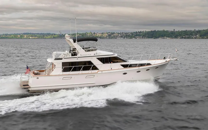  Yacht Photos Pics 1989 Ocean Alexander 50 Sedan yacht cruising on open water under cloudy skies.