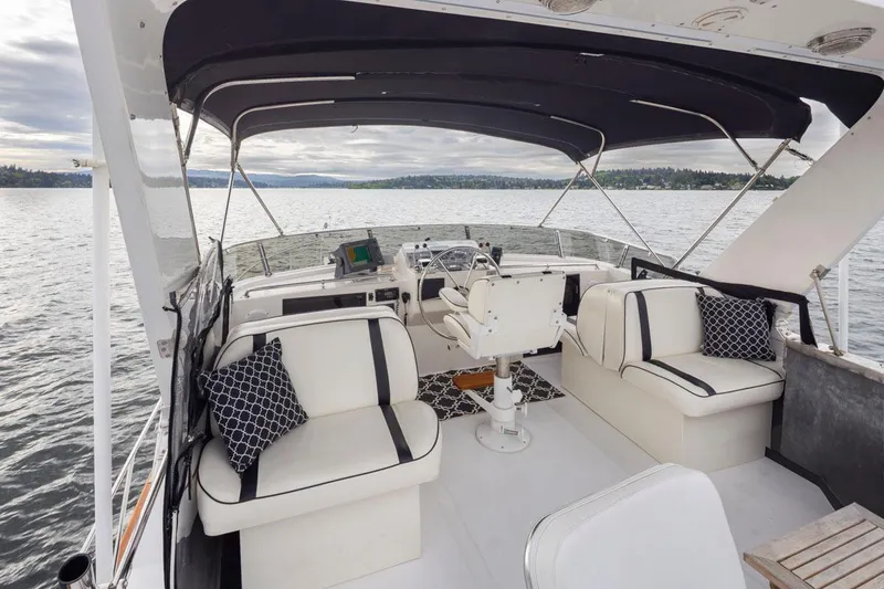  Yacht Photos Pics 1989 Ocean Alexander 50 Sedan yacht interior with seating, steering, and water view.