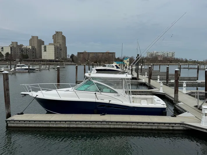  Yacht Photos Pics 2011 Rampage 34 IPS boat docked in a marina with cityscape background.