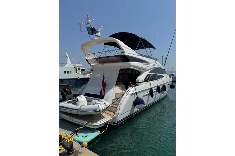  Yacht Photos Pics Luxury 2012 Princess 60 yacht docked at marina under clear blue sky.