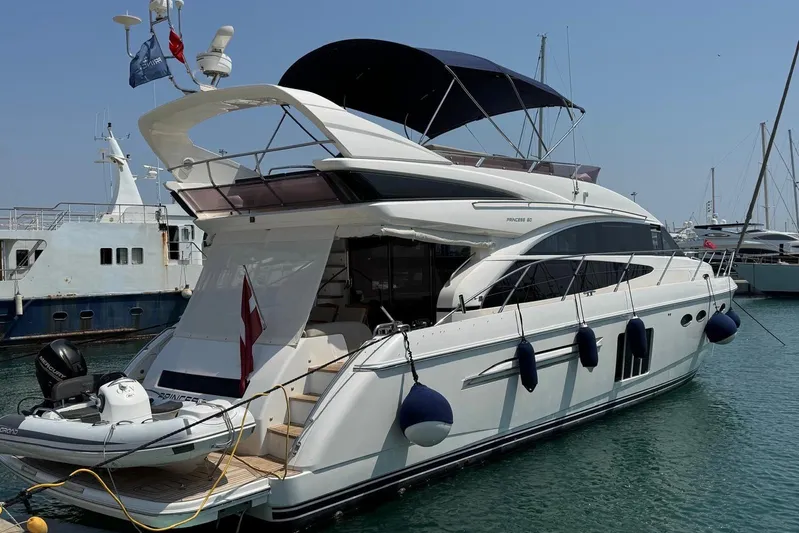  Yacht Photos Pics Luxury 2012 Princess 60 yacht docked in marina, featuring sleek design and spacious deck.