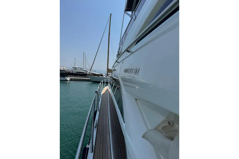  Yacht Photos Pics Side view of a 2012 Princess 60 yacht docked in a marina.