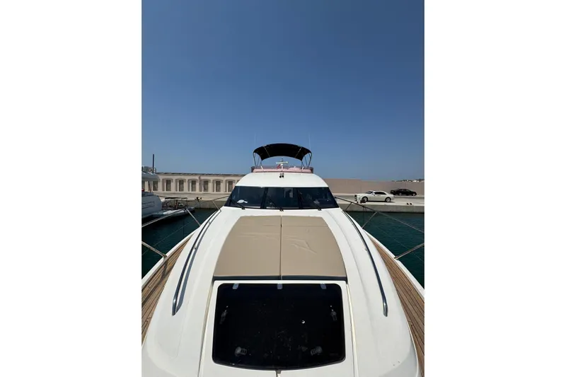  Yacht Photos Pics Luxury 2012 Princess 60 yacht docked at marina under clear blue sky.