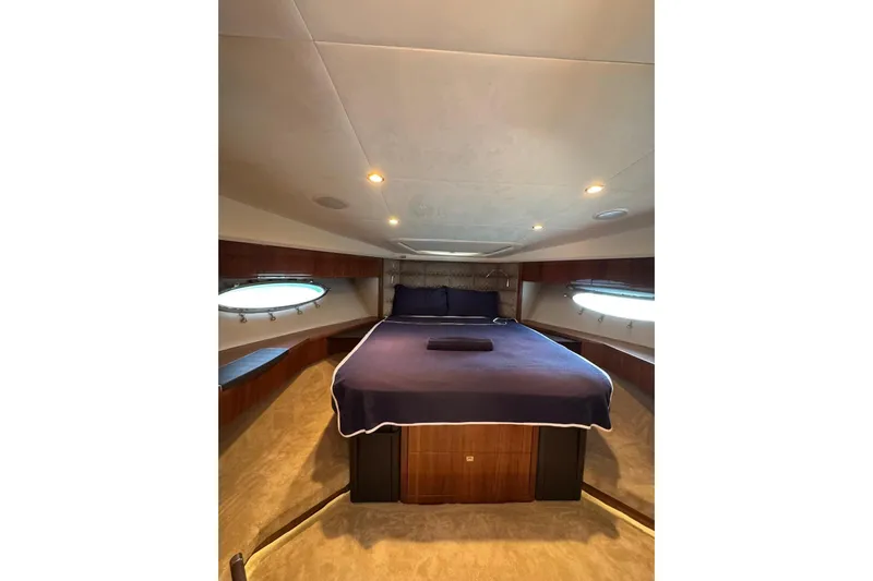  Yacht Photos Pics Luxurious bedroom interior of 2012 Princess 60 yacht with elegant bedding and ambient lighting.