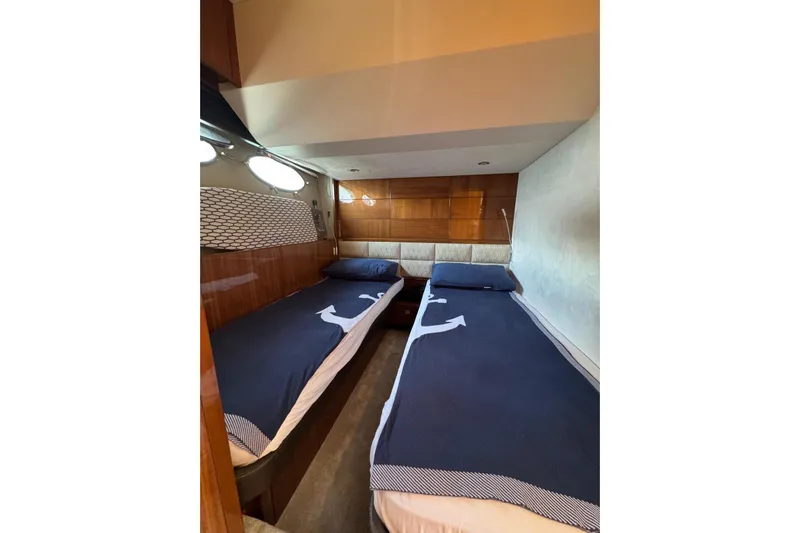  Yacht Photos Pics Luxurious twin cabin in 2012 Princess 60 yacht with nautical-themed bedding.