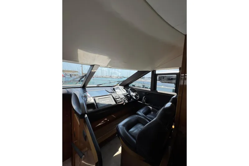  Yacht Photos Pics Interior view of 2012 Princess 60 yacht cockpit with steering wheel and navigation system.