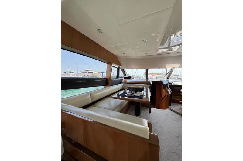  Yacht Photos Pics Luxurious interior of 2012 Princess 60 yacht with elegant seating and panoramic windows.